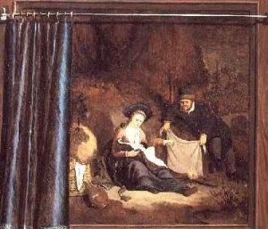 Lady seated in front of a fireplace with ham and bread on a table