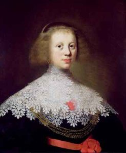 Still life of melon grapes pomegranate walnuts on a pewter plate and peaches