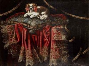 A nautilus cup a paten ewers and a gilt dish on a carpet draped over a ledge